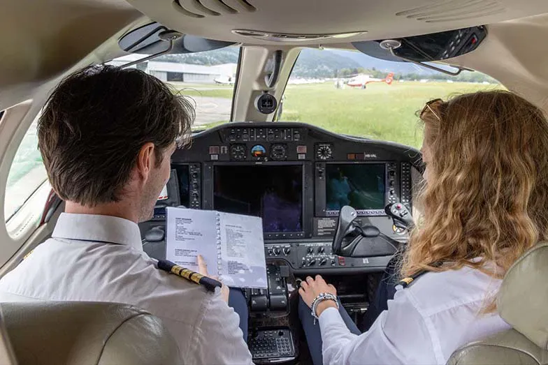 Pilots preparing for ICAO English exam with checklist and guidance